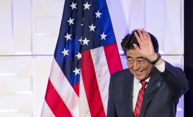 Japan's Prime Minister Abe waves after speaking at a luncheon in Los Angeles
