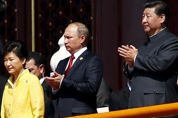 Chinese President Xi Jinping, Russia's President Vladimir Putin and South Korea's President Park Geun-hye observe from Tiananmen Gate as the military parade marking the 70th anniversary of the end of World War Two begins in Beijing