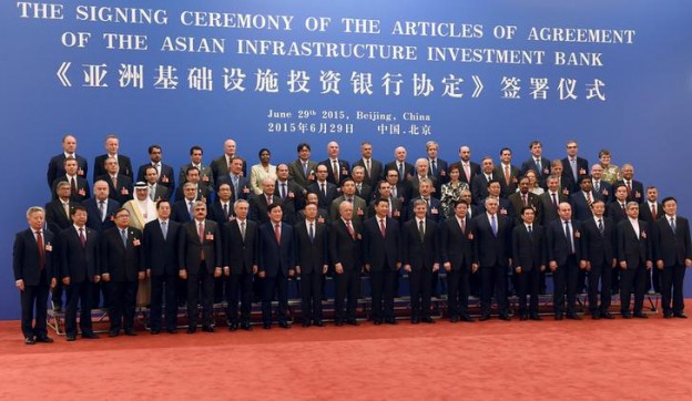Chinese President Xi Jinping (C, front) poses for a group photo with the delegates attending the signing ceremony for the Articles of Agreement of the Asian Infrastructure Investment Bank (AIIB) at the Great Hall of the People in Beijing June 29, 2015. China will hold a 30.34 percent stake in the Asian Infrastructure Investment Bank (AIIB), the Finance Ministry said on Monday, making Beijing the largest shareholder in a bank that is expected to project the country's growing influence. REUTERS / POOL/WANG ZHAO      TPX IMAGES OF THE DAY