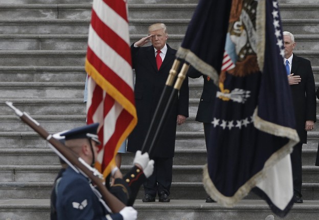 Newly inaugurated U.S. President Donald Trump salutes as he presides over a military parade during Trump's swearing ceremony in Washington, U.S., January 20, 2017.   REUTERS/Mike Segar  - RTSWKSW