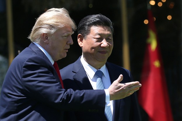 U.S. President Donald Trump and China's President Xi Jinping chat as they walk along the front patio of the Mar-a-Lago estate after a bilateral meeting in Palm Beach, Florida, U.S., April 7, 2017. REUTERS/Carlos Barria - RTX34M80