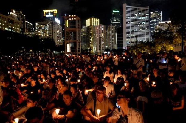 People take part in a candlelight vigil to mark the 29th anniversary of the crackdown of pro-democracy movement at Beijing's Tiananmen Square in 1989, at Victoria Park in Hong Kong, China June 4, 2018. REUTERS/Bobby Yip - RC1B53B40370