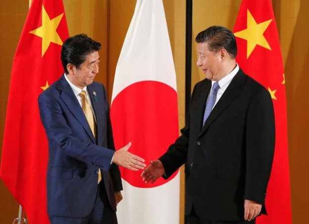 Chinese President Xi Jinping and Japanese Prime Minister Shinzo Abe show their hands for a handshaking at the start of talks at a hotel prior to the G20 Summit at the International Exhibition Center in Osaka, western Japan, June 27, 2019. Kimimasa Mayama/Pool via REUTERS - RC1625B27EB0