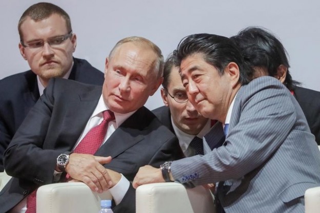 Russian President Vladimir Putin (L, 1st row) and Japanese Prime Minister Shinzo Abe (R, 1st row) attend an international judo tournament on the sidelines of the Eastern Economic Forum in Vladivostok, Russia September 12, 2018. Mikhail Metzel/TASS Host Photo Agency/Pool via REUTERS - RC149A59C230