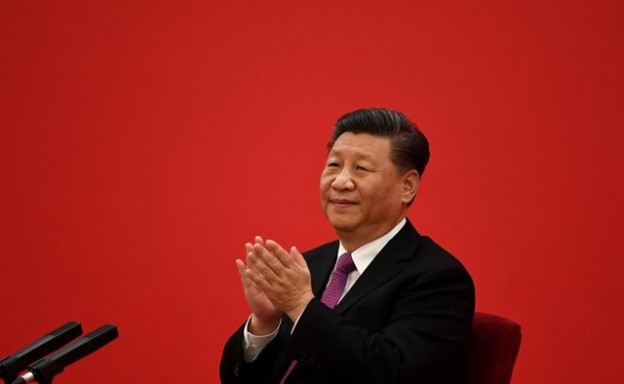 China's President Xi Jinping applauds to Russian President Vladimir Putin as they talk via a video link, from the Great Hall of the People in Beijing, China December 2, 2019.  Noel Celis/Pool via REUTERS - RC2YMD9ZLWUQ
