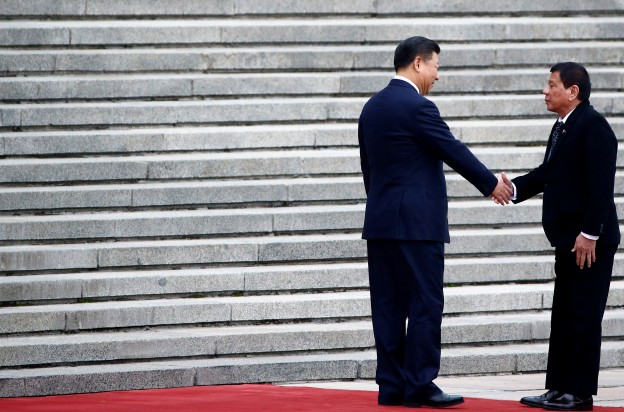 Philippines President Rodrigo Duterte and Chinese President Xi Jinping shake hands as they attend a welcoming ceremony at the Great Hall of the People in Beijing, China, October 20, 2016. REUTERS/Thomas Peter - S1BEUHZJZGAA