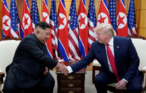 U.S. President Donald Trump shakes hands with North Korean leader Kim Jong Un as they meet at the demilitarized zone separating the two Koreas, in Panmunjom, South Korea, June 30, 2019. REUTERS/Kevin Lamarque - RC1FD6F66FF0